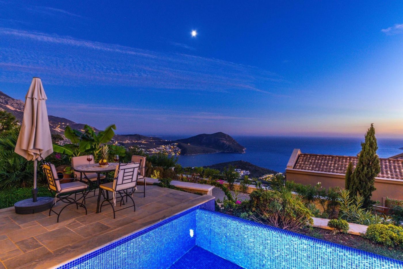 Pool and sea at dusk from the same villa